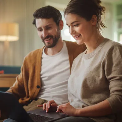 An Aurora couple reviewing HVAC financing options together on a laptop at home