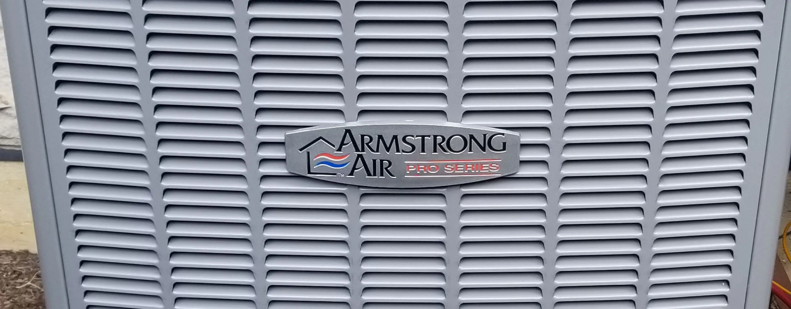 AccuMax technicians servicing a central air conditioning system at an Aurora, IL home