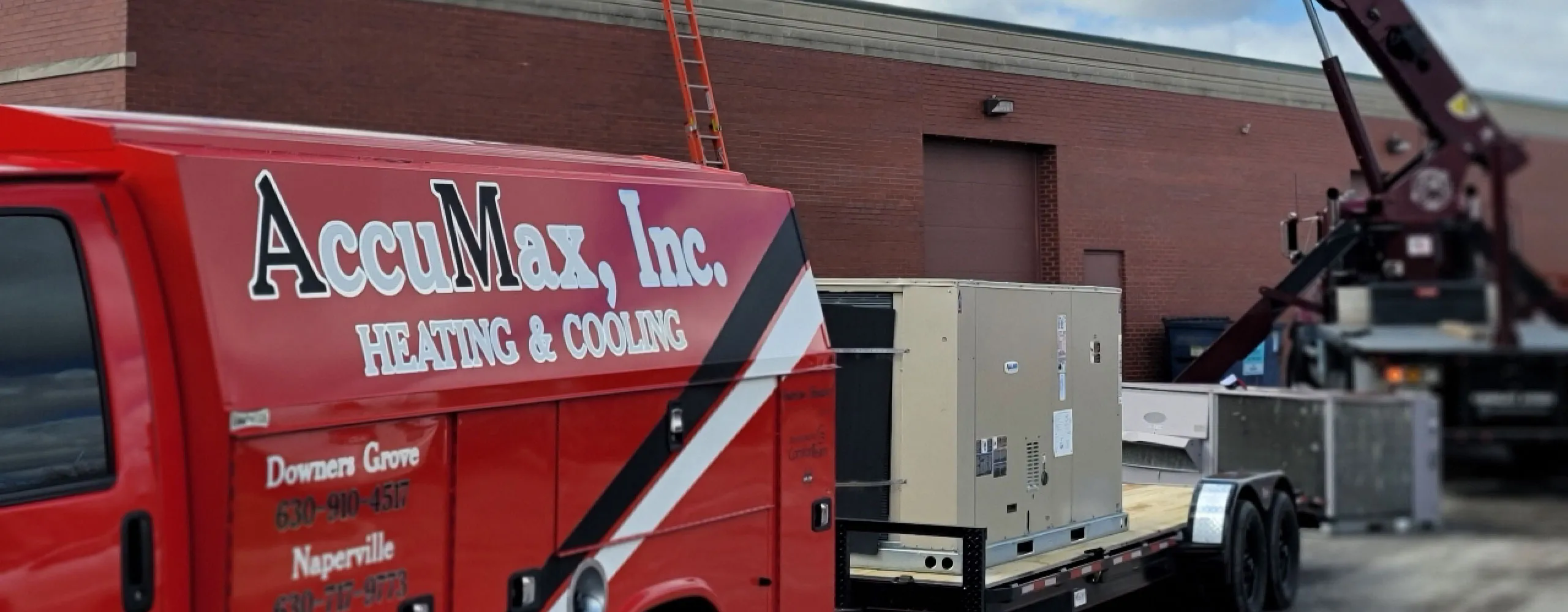 AccuMax technicians servicing a commercial rooftop HVAC unit in Aurora, IL