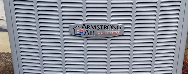 Newly installed Armstrong Air Pro Series air conditioner condenser outside an Aurora, IL home