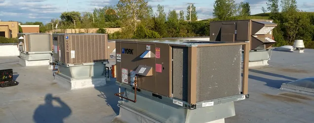 Commercial York rooftop packaged HVAC units installed on a flat commercial roof