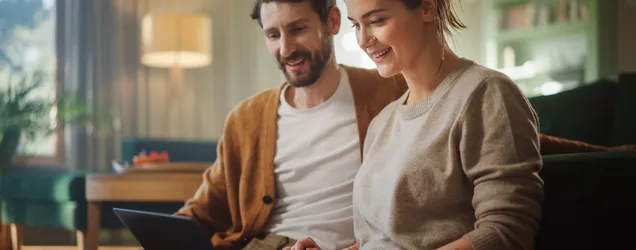 Couple reviewing HVAC financing options together on a laptop at home