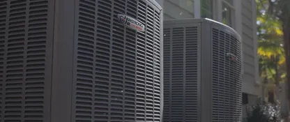 Two Armstrong Air Pro Series heat pump units installed beside a home