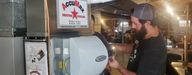 AccuMax technician installing a whole-home humidifier system in an Aurora, IL home