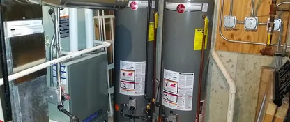 Gas water heaters installed in a home utility room by AccuMax